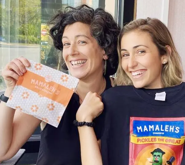 Two women holding Mamaleh’s merchandises